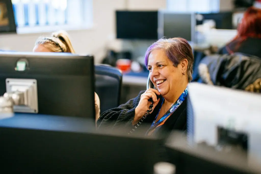 A female member of staff answering the phone.