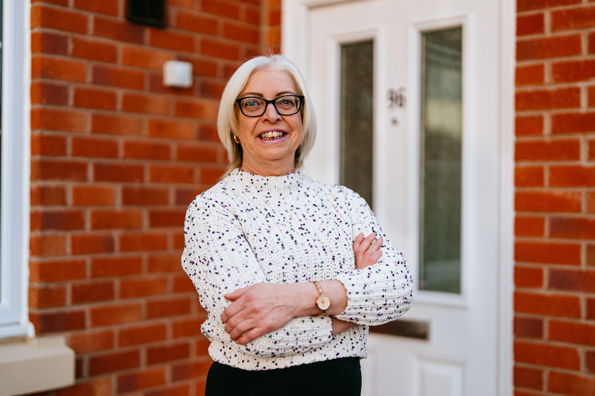 A lady stood in front of her home.
