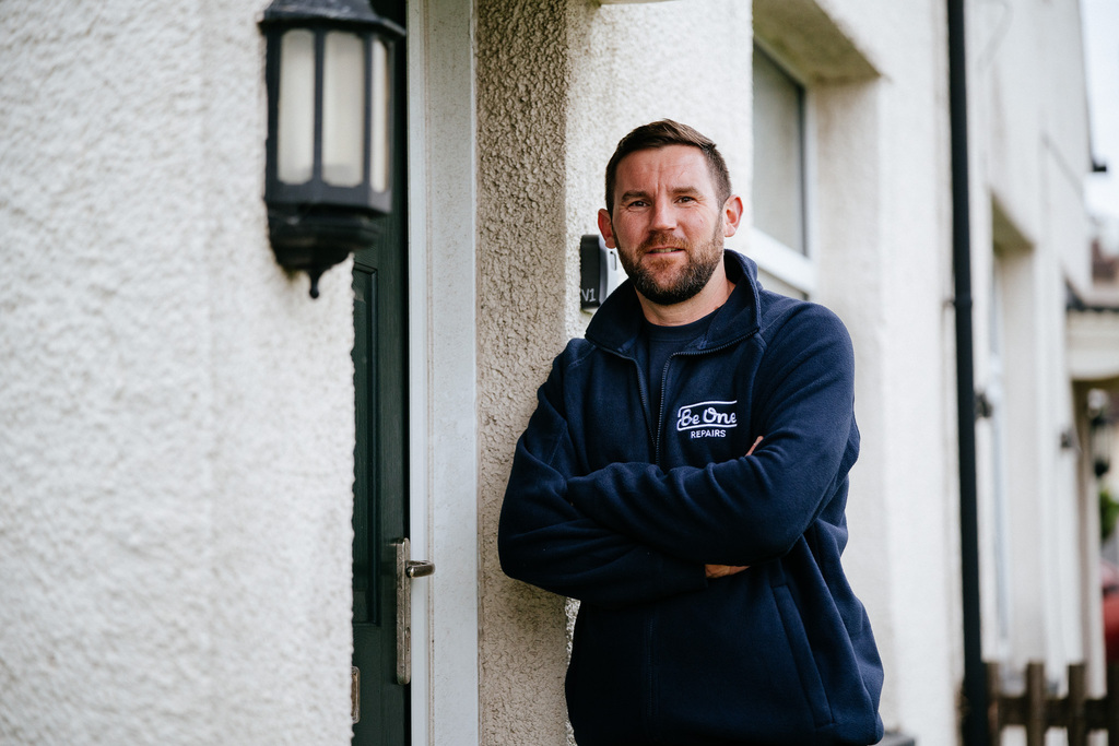 Male repairs operative stood outside the front door of a Be One Homes property.