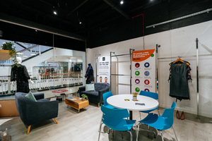 An interior shot of our Bolton UCAN Centre. It shows a pull-up banner that lists the services available at the centre, along with seating areas for visitors.